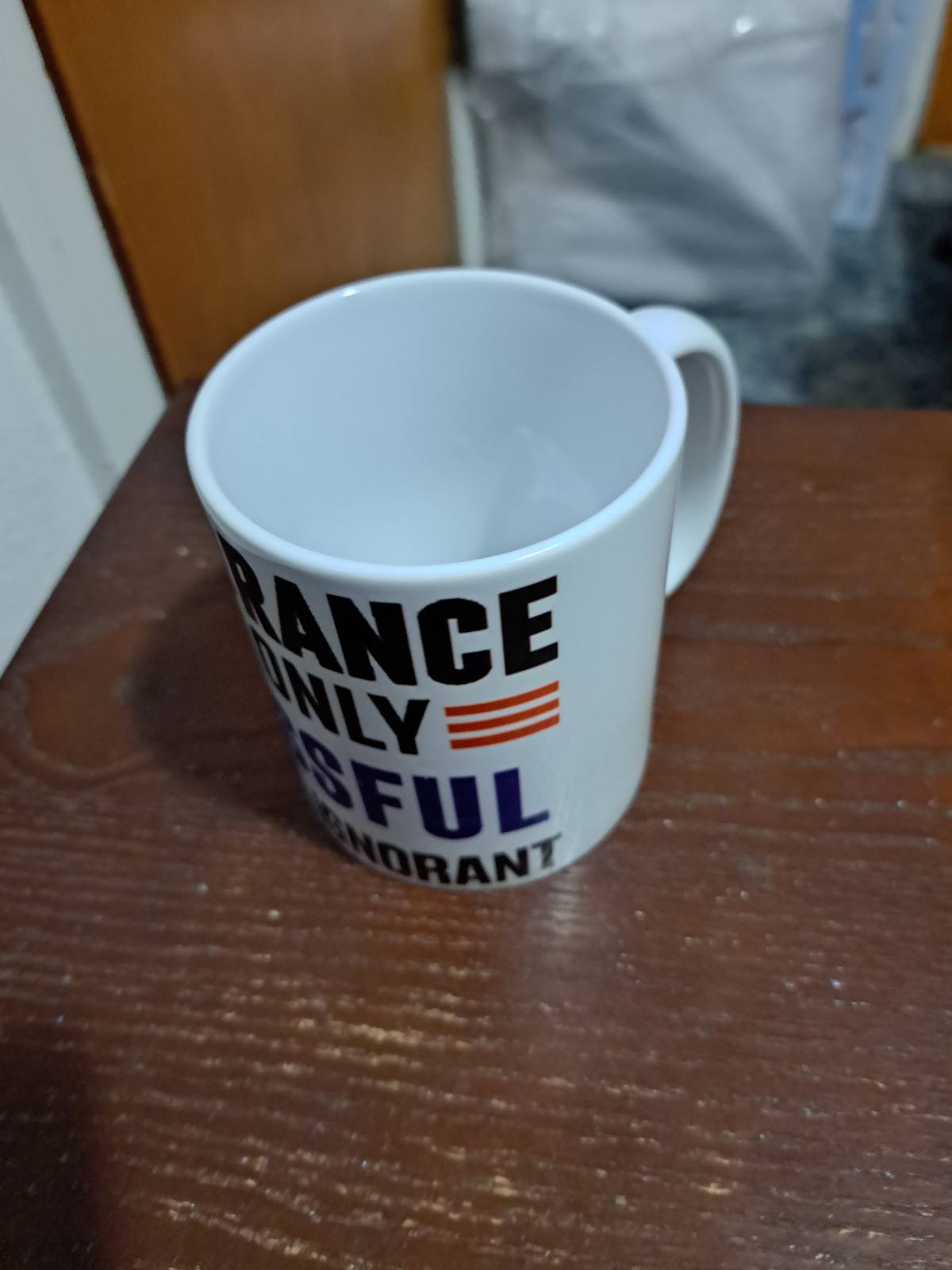 Fantasy Tees Plus Ignorance is Bliss Coffee Mug with bold black and blue text on white ceramic